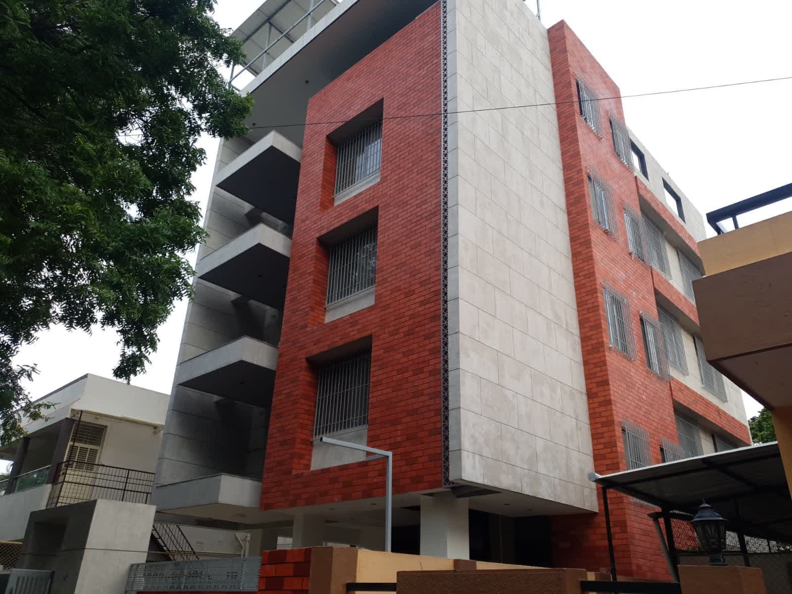 Finished exterior facade in red brick and cream stone cladding