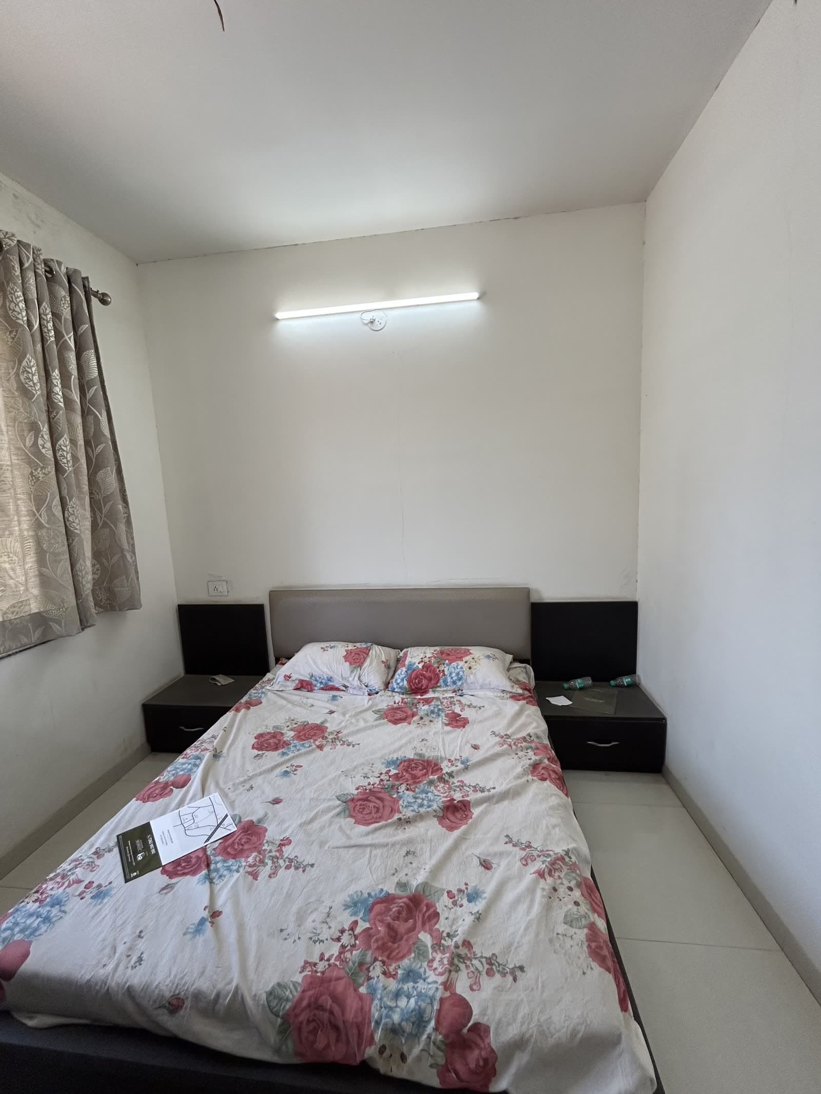 Finished bedroom with wardrobe and floral bedspread