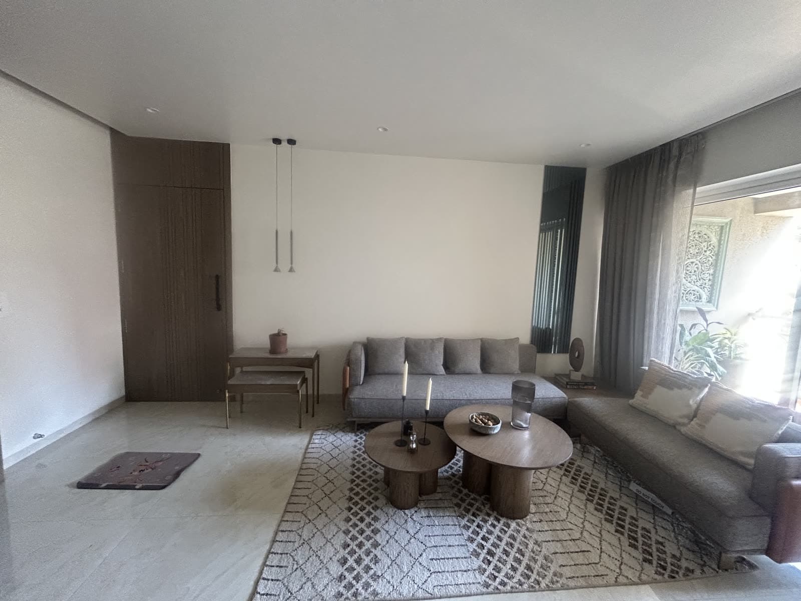 Finished neutral-tone living room repaint with wood accent wardrobe