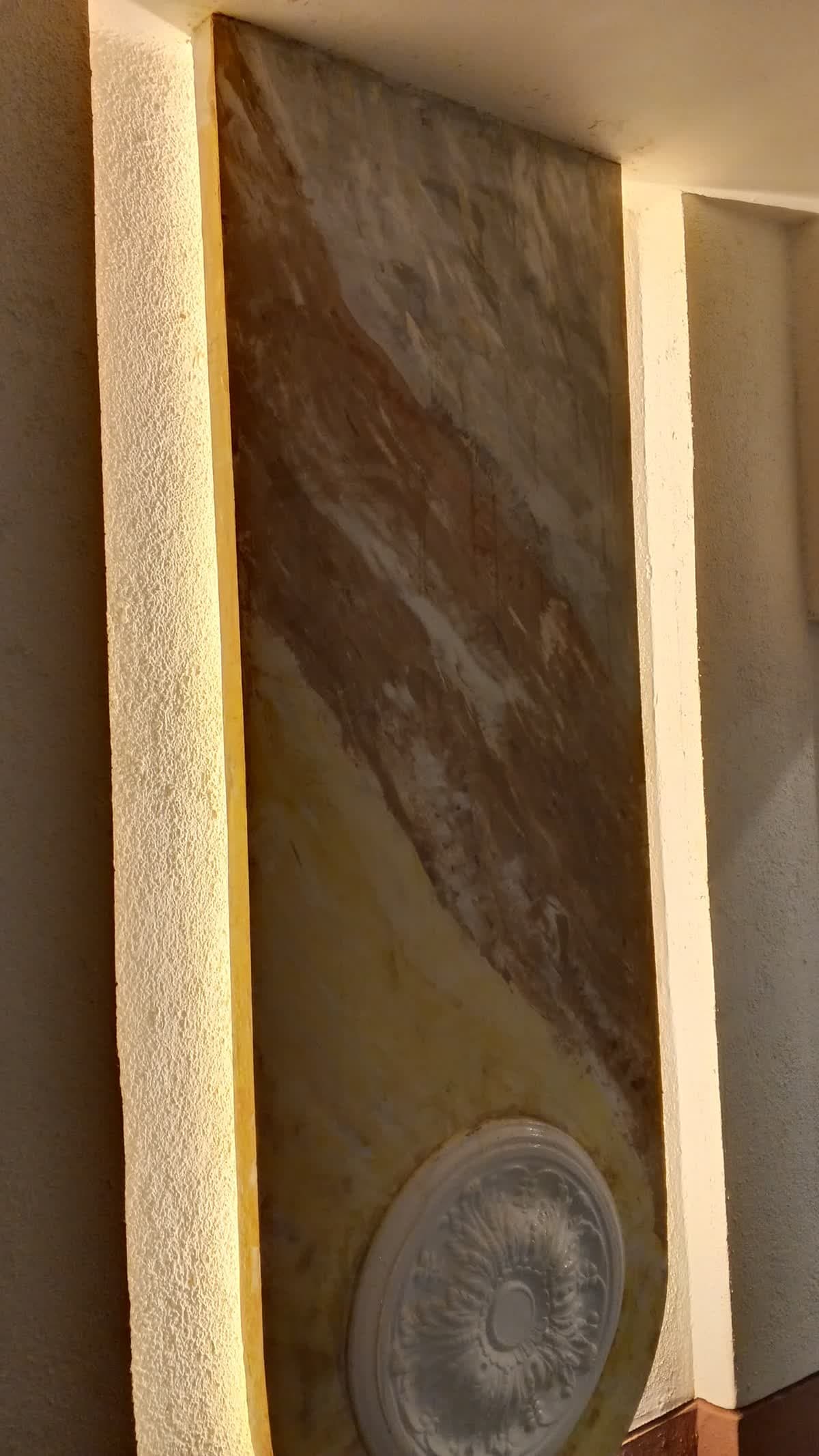 Marble-effect wall panel with a decorative round medallion